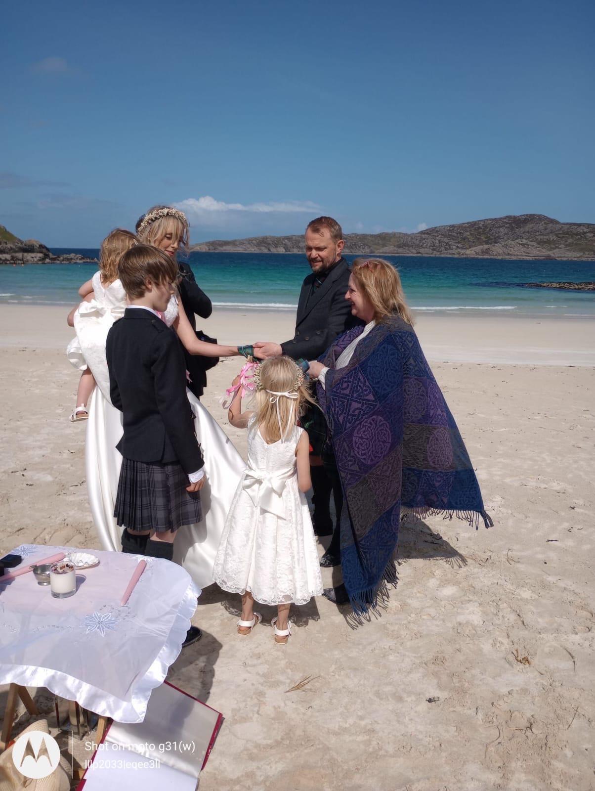 Beach wedding ceremony with family on Scottish coast